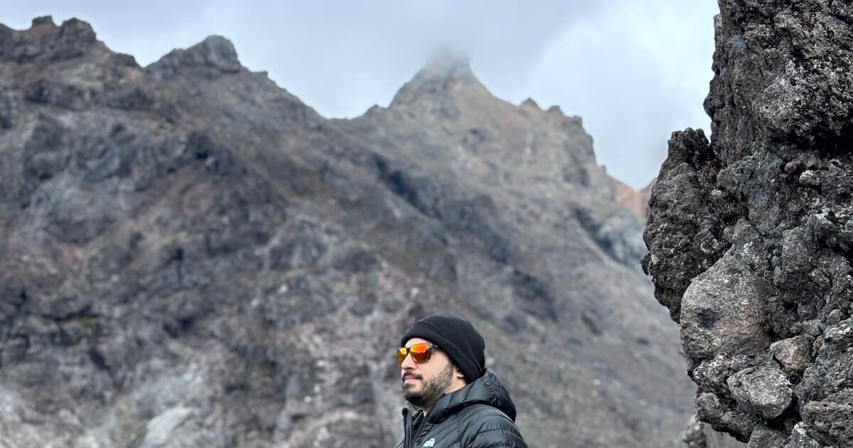 Nick Rossi standing on a volcanic ridge